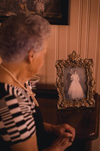 senior citizen looking at wedding photo